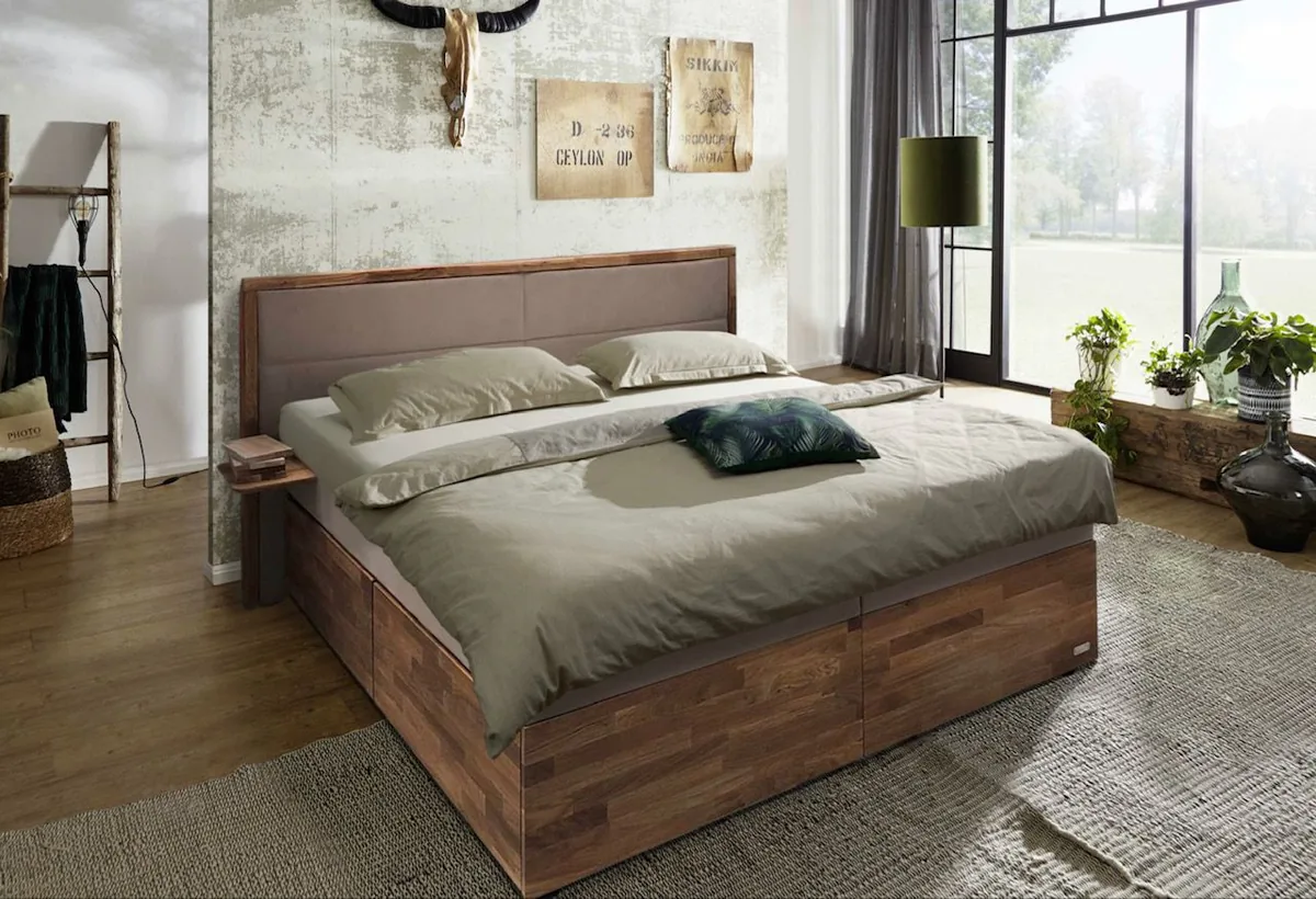 Bett mit Holzrahmen und hellgrüner Bettwäsche in einem Schlafzimmer